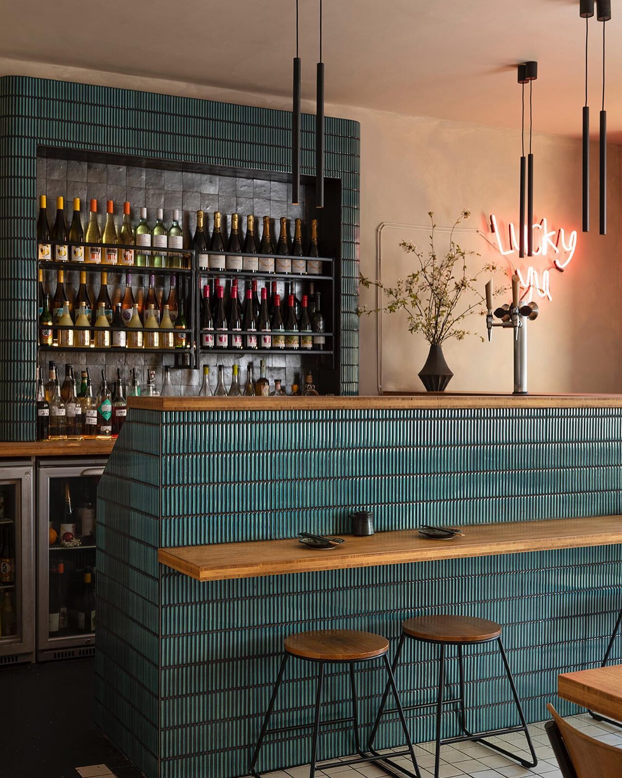 Teal tiled back bar with bottle display
